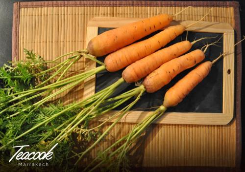 a bunch of carrots sitting on a cutting board at Teacook Marrakech in Ouled el guerne