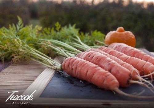 a bunch of carrots sitting on a cutting board at Teacook Marrakech in Ouled el guerne