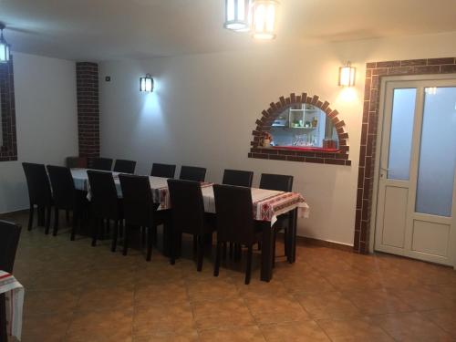 a dining room with a table and chairs at Casa Ade in Slănic