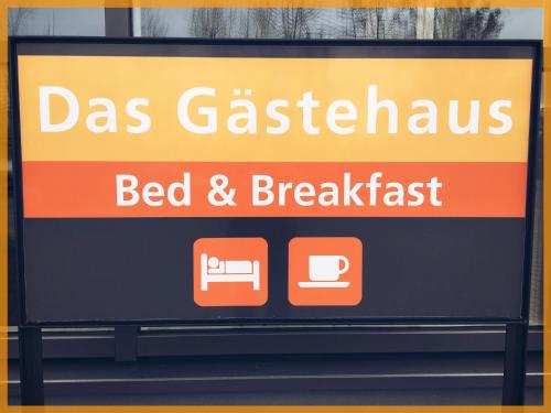 a sign for a bed and breakfast restaurant at Das Gästehaus Eimeldingen in Eimeldingen