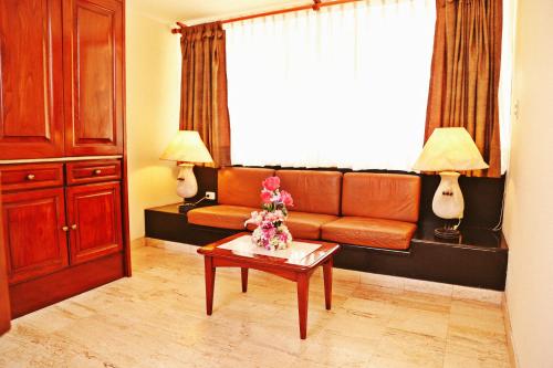 a living room with a couch and a table at Apart Hotel Caminos del Inca in Lima
