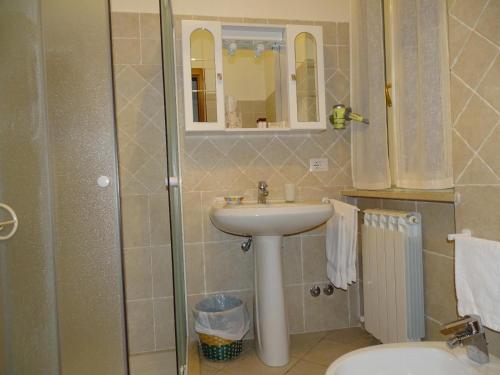 a bathroom with a sink and a shower at Residence Terra Dei Santi Country House in Spello