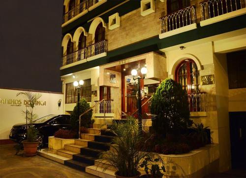 a building with a car parked in front of it at Apart Hotel Caminos del Inca in Lima
