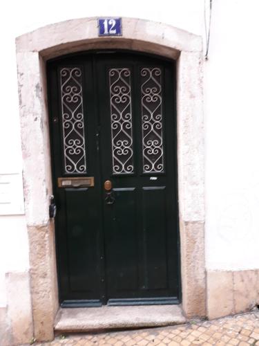 a black door with a number on it at Flat in historic neighbourhood in Lisbon