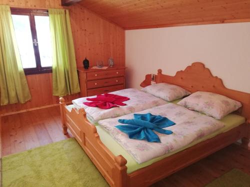 a bedroom with a bed with two bows on it at Ferienhaus Schnider in Galgenul