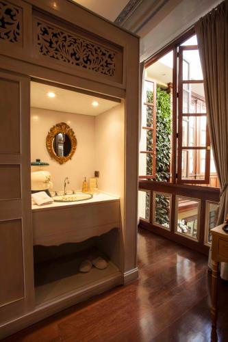 a bathroom with a sink and a mirror at The Orchids in Bogotá