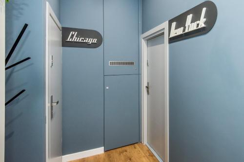 a hallway with a door and a sign on the wall at Bliss Apartments in Poznań