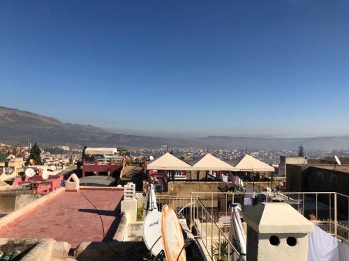 a group of white umbrellas on top of a roof at Le Grand Alcazar - Riad in Fès