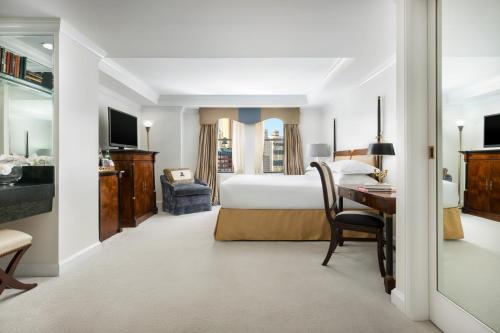 a hotel room with a bed and a desk at The Michelangelo Hotel in New York