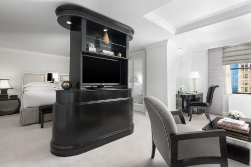 a living room filled with furniture and a tv at Michelangelo Hotel in New York