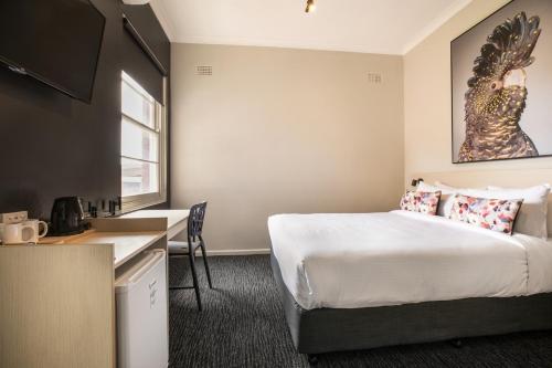 a hotel room with a bed and a desk at Nightcap at the Charles Hotel in Wollongong