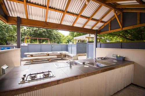 a kitchen with two sinks and a counter top at Hastings TOP 10 Holiday Park in Hastings