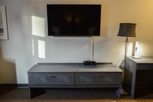 a dresser with a flat screen tv on top of it at Bar-B Inn in Assiniboia