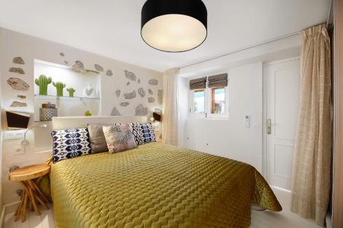 a bedroom with a bed with a yellow bedspread at "NEW" Deluxe designer Villa Infinity, with Panoramic sea views,own exclusive heated private pool, subtropical gardens in Tías