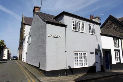 a white building on the side of a street at York House in Conwy