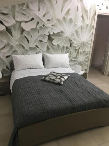 a bedroom with a large bed with a floral wallpaper at PEPPE'S HOME Luxury and relax apartament in Gragnano