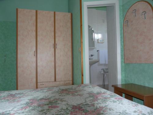 מיטה או מיטות בחדר ב-Hotel Vecchia Rimini