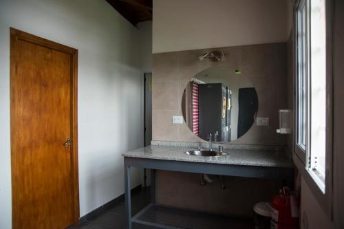 a bathroom with a sink and a mirror at Feliza Hostel in Villa Carlos Paz