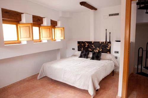 a bedroom with a white bed with black pillows at Happy Apartments Valencia – Lope de Vega in Valencia