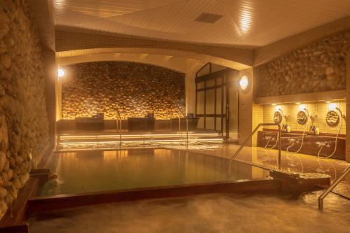 
a large room with a large pool of water at Lime Resort Myoko in Myoko
