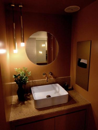 a bathroom with a sink and a mirror at Tong Tong Petit Hotel in Seoul