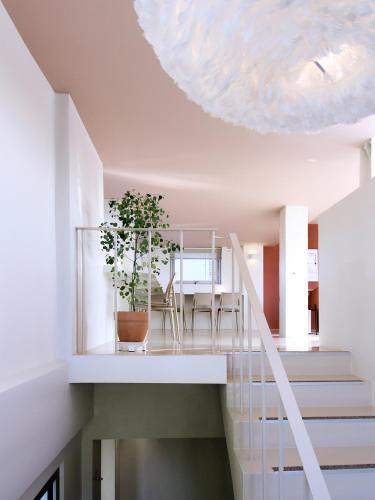 a white staircase with a potted plant on it at Tong Tong Petit Hotel in Seoul