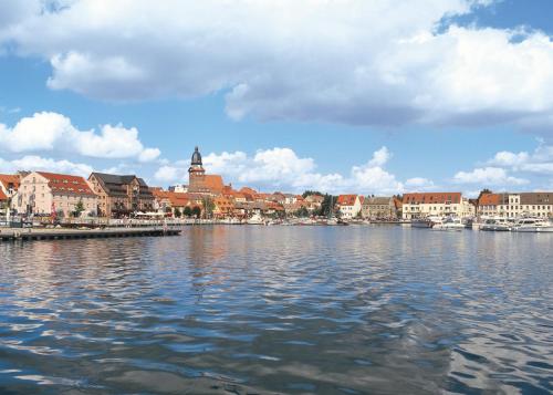 a large body of water with buildings and a city at Hotel Am Brauhaus in Waren