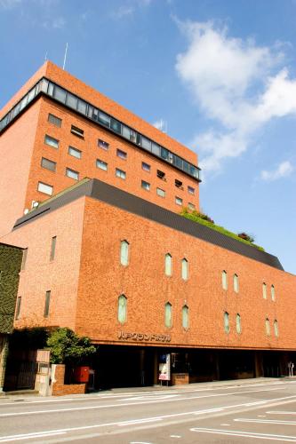 a large brick building with a street in front of it at Hachinohe Grand Hotel in Hachinohe