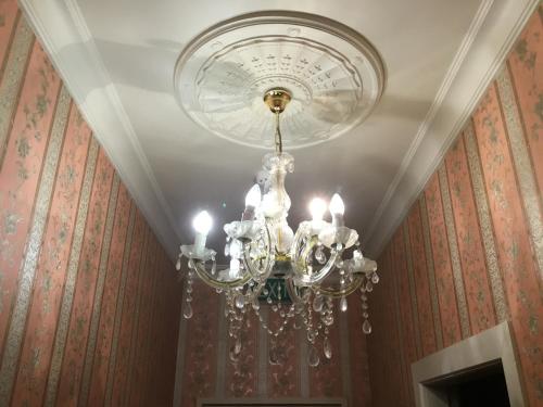 a chandelier hanging from a ceiling in a room at Royal Mail Hotel in Lumsden