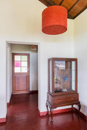 an empty room with a cabinet and a door at Cranganor History Café & Riverside Château in Parūr