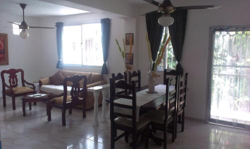 a living room with a table and chairs and a couch at Dre Broeders Apartments Juan Dolio in Juan Dolio