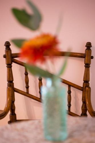a vase with a flower sitting on top of a rail at Belma Boutique Bed and Breakfast in Lima