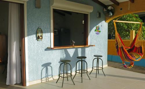 a group of stools in front of a wall at villa stenella in Bouillante