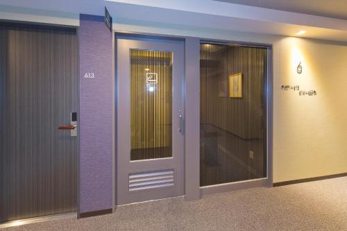 a door in a room with purple walls at Hotel Route-inn Yamaguchi Yuda Onsen in Yamaguchi
