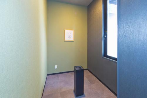 a hallway with a room with a table and a window at Hotel Route-inn Yamaguchi Yuda Onsen in Yamaguchi