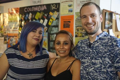 a man and two women posing for a picture at The Wandering Paisa in Medellín