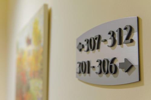 a clock on a wall next to a picture at Hotel Pappas in Kiáton