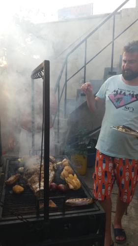 a man standing in front of a grill with food at Shining Line in Koggala