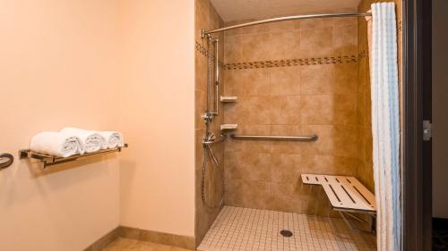 a shower with a glass door in a bathroom at Best Western Plus Airport Inn & Suites in Salt Lake City
