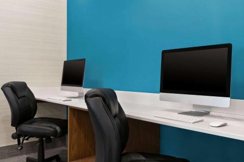an office with a desk with a computer and two chairs at Days Inn by Wyndham Kingston in Kingston