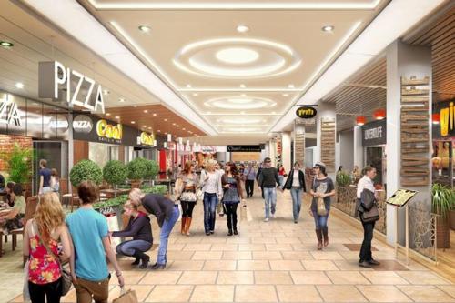 a group of people walking through a shopping mall at Birtley's Amethyst, 3 bedroom Apt ,sleeps 6 Guest in Birtley