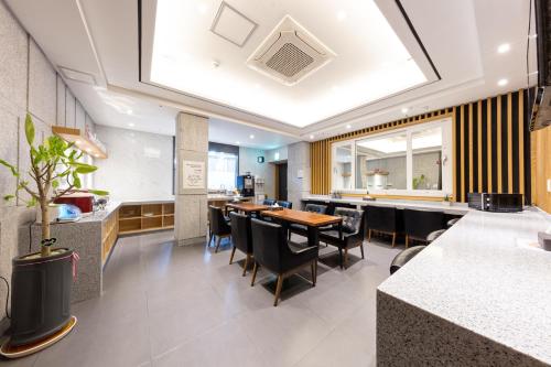 a dining room with a table and chairs at Stay Hotel in Gwangju