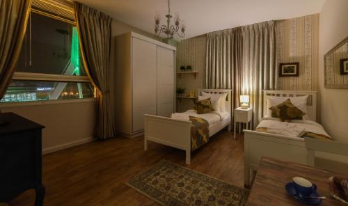 a bedroom with two beds and a window at Casa Boutique Hotel in Nahariyya