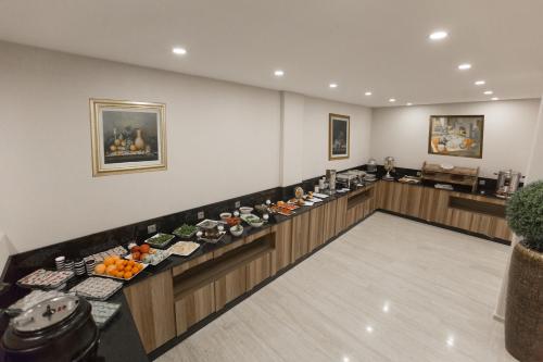 a room with a buffet of food on display at Piskin Hotel in Denizli