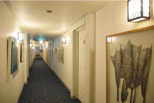 a hallway in a building with paintings on the walls at Jeonju Hansung hotel in Jeonju