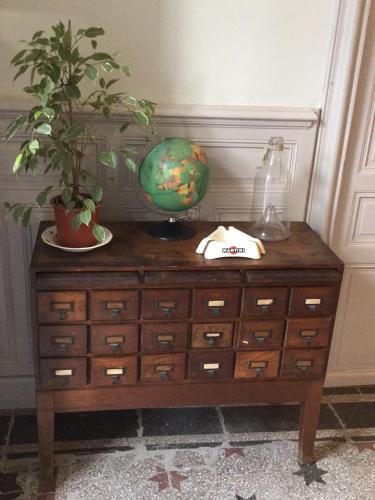 a wooden dresser with a globe on top of it at Chez Les Brocs B&B in Canet d'Aude