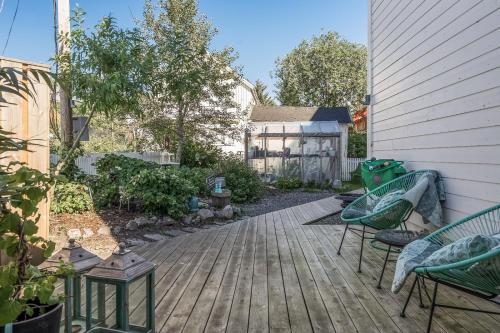 a patio with two green chairs and a house at Opsahl Gjestegaard in Bodø