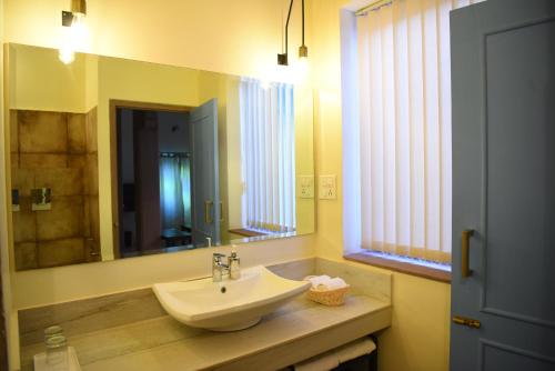 a bathroom with a sink and a mirror at Baijoo Niwas in Jodhpur