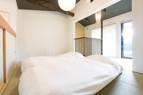 Ένα ή περισσότερα κρεβάτια σε δωμάτιο στο Guesthouse Tonton Nobu