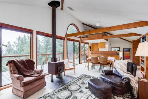 a living room with a wood stove and a dining room at The Eagle's Nest in Otis